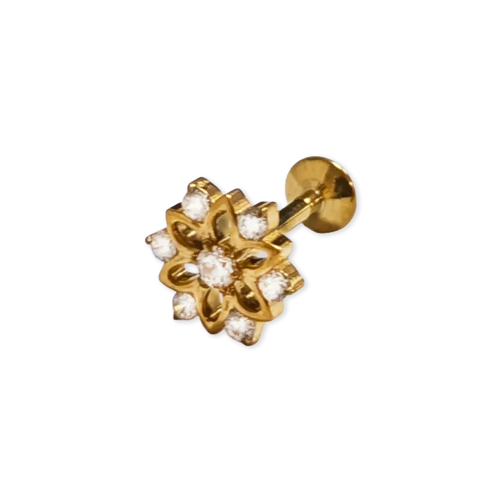 Gold coloured decorative body jewellery stud set with gems