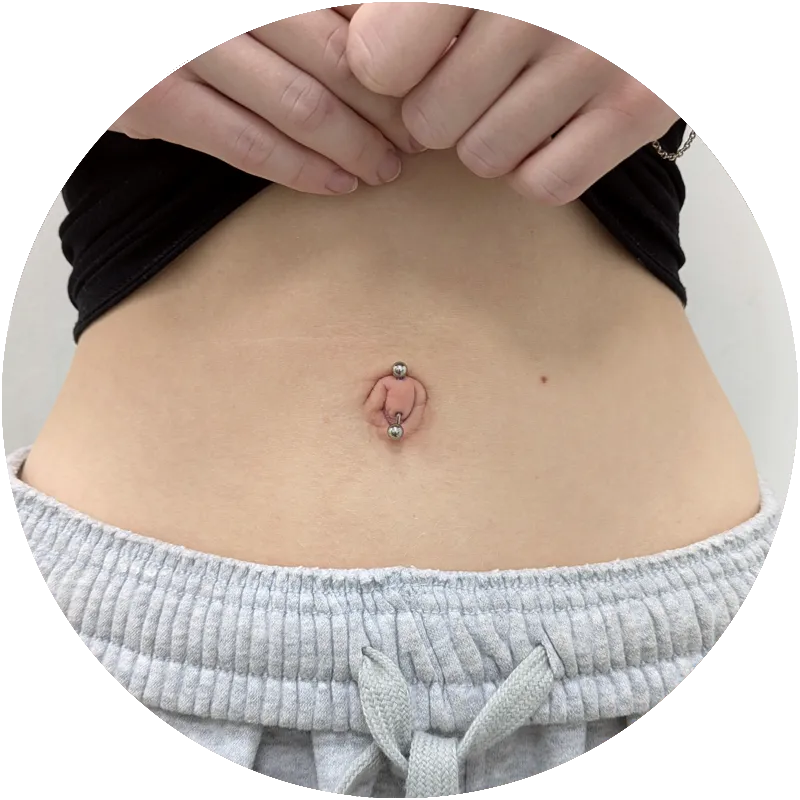 Close up of a true navel piercing