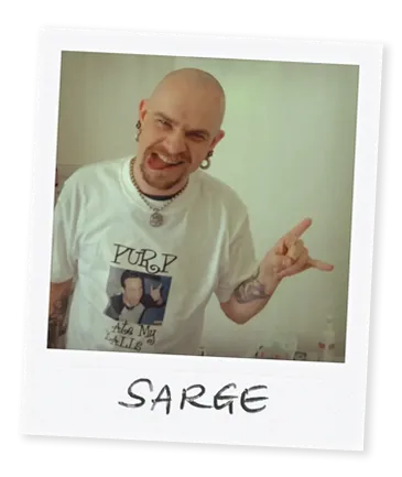 Polaroid image of piercer Sarge from Bournemouth showing rock horns with his hand