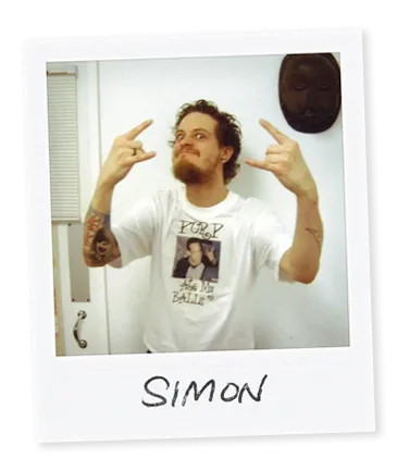 Polaroid image of piercer Simon from Bournemouth showing rock horns with his hands