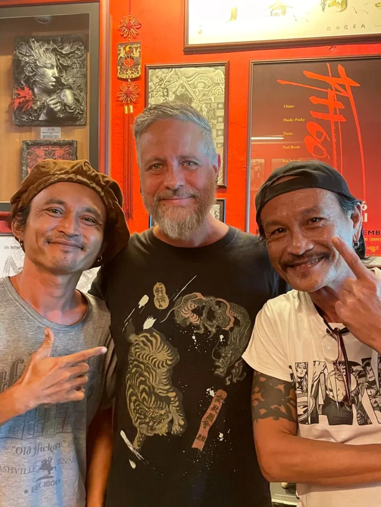 Simon the piercer from Metal Fatigue in Bournemouth smiling with two piercers in Borneo