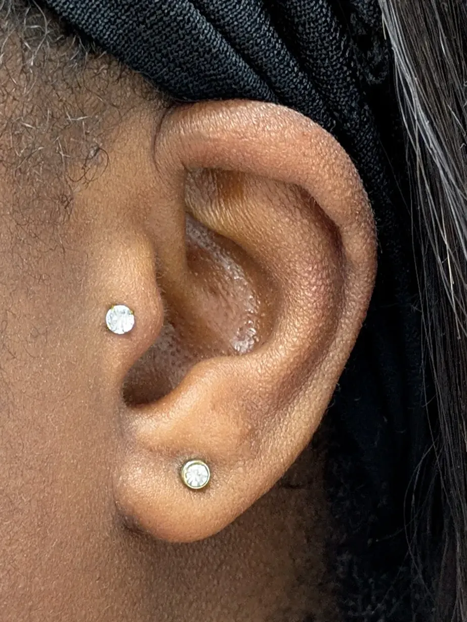 Close up of an ear with a tragus and earlobe piercing