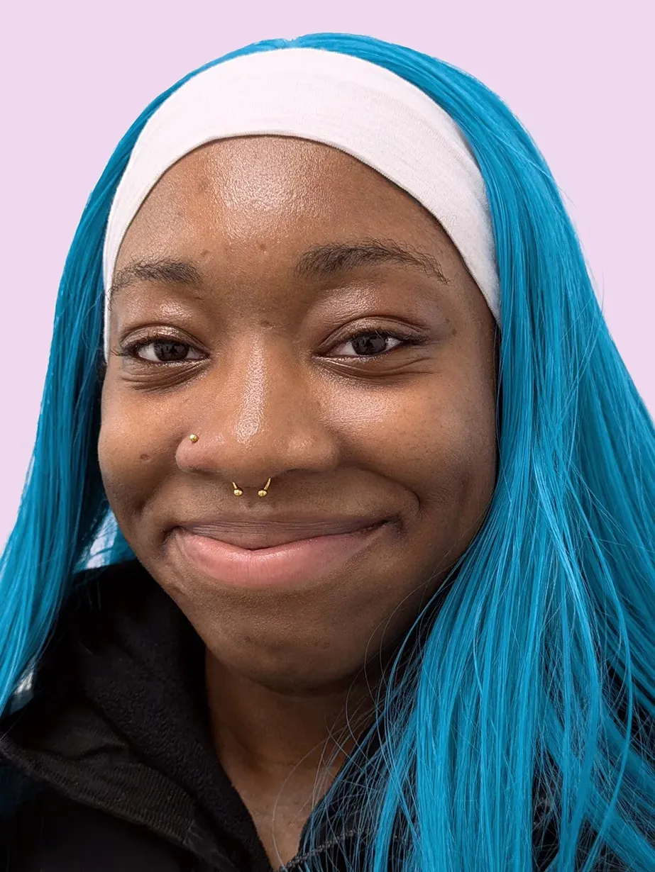 Woman with blue hair and a gold septum piercing