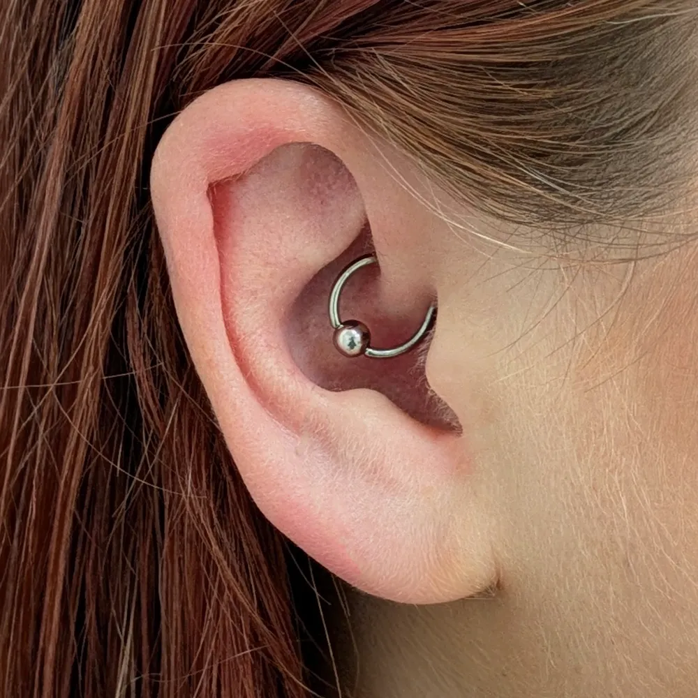 Close up of an ear with a daith piercing, pierced with a titanium BCR