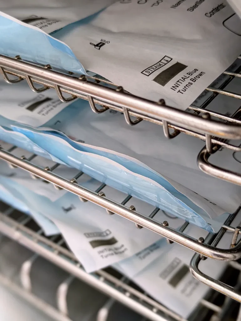 Close up of sterilised tools in their pouches, in an autoclave